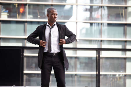 Portrait of a businessman in front of skyscrapersの写真素材