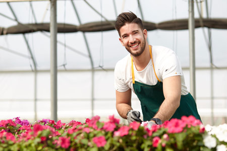 Portrait of a smiling greenhouse workerの写真素材