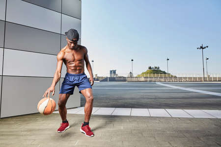 Portrait of afro american male basketball player with a ballの写真素材