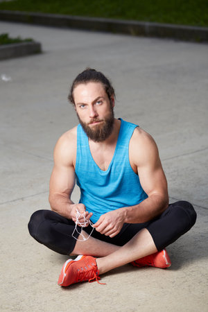 Having had a good workout, a fit, healthy man takes a few moments to relax