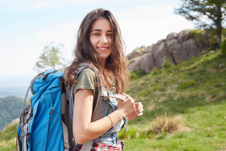 Traveling girl with backpack hiking in the mountains, eco tourismの写真素材