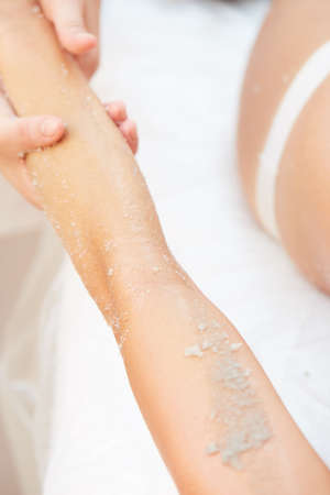 Woman Getting a Salt Scrub Beauty Treatment in the Health Spaの写真素材