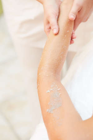 Woman Getting a Salt Scrub Beauty Treatment in the Health Spaの写真素材