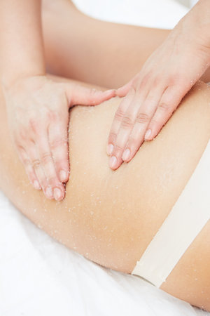 Woman Getting a Salt Scrub Beauty Treatment in the Health Spa
