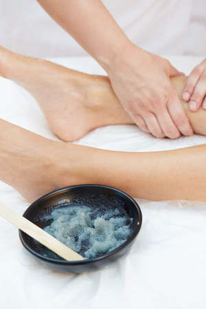 Woman Getting a Salt Scrub Beauty Treatment in the Health Spaの写真素材