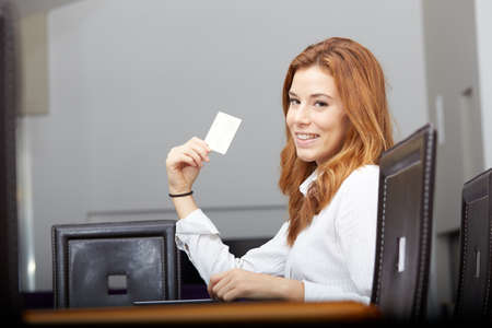 Pretty woman doing online shopping with laptop at home in the living roomの写真素材