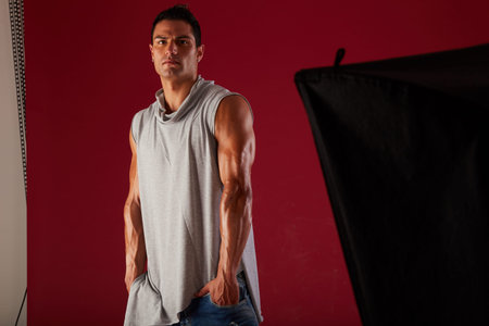 Young beautiful male model posing in professionally equipped studio