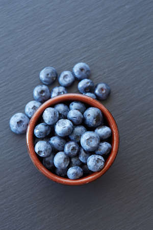 Blueberry on ceramic background. Ripe and juicy fresh picked blueberries closeupの写真素材