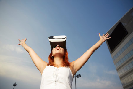 Happy young woman using a virtual reality headset
