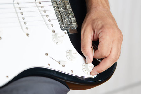 Close up of a lefty electric guitar being played