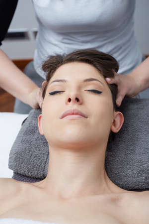 Female Enjoying Relaxing Back Massage In Cosmetology Spa Centerの写真素材