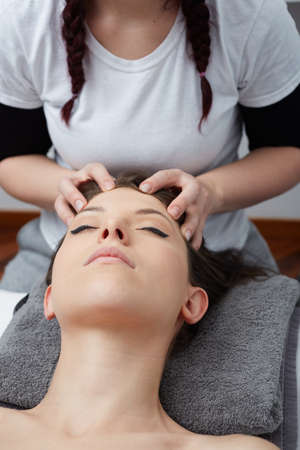 Female Enjoying Relaxing Back Massage In Cosmetology Spa Centerの写真素材