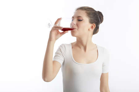 young woman hold and drink a glass of red wineの写真素材