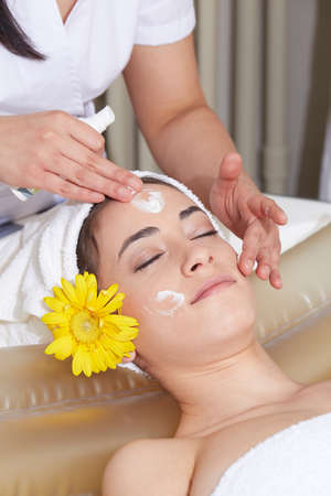 Female Enjoying Relaxing face Massage In Cosmetology Spa Centerの写真素材