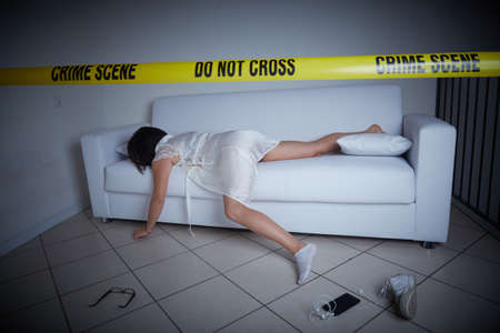 crime scene - woman liyng dead on the sofaの写真素材