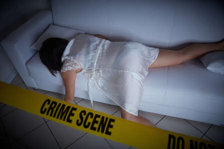 crime scene - woman liyng dead on the sofaの写真素材