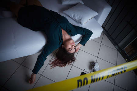 crime scene - woman liyng dead on the sofaの写真素材