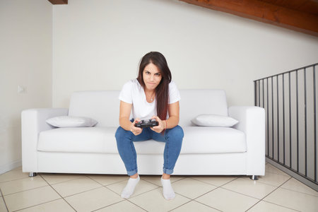 pretty woman play videogames on sofa