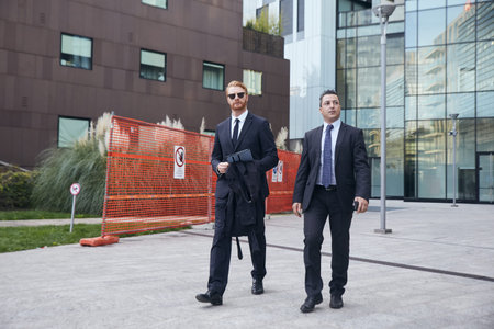 business people working outside office building