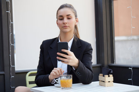young businesswoman talking to mobile and drink a cup of coffee