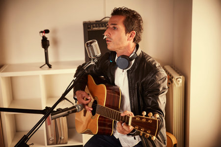 guitar player recording at home studio
