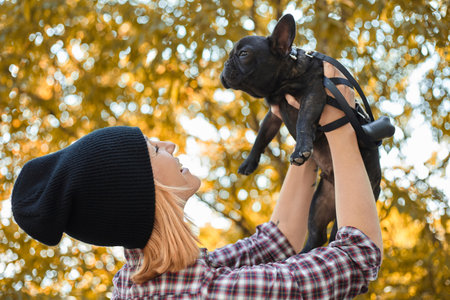 Closeup on happy young woman with dog outdoors in autumnの写真素材