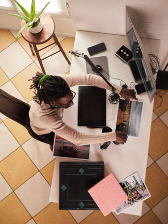 Graphic designer / photographer working in home officeの写真素材