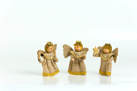 Three wooden angels on white backgroundの写真素材