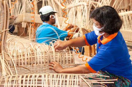 Surabaya / Indonesia - June 19, 2008: Process of weaving rattan in a furniture factoryのeditorial素材