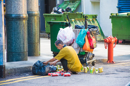 Old man scavenger cans and used items for recycling