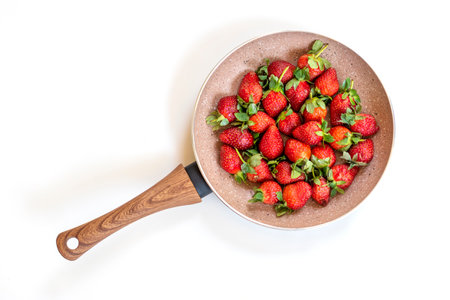 Strawberries in a pan, white backgroundの写真素材