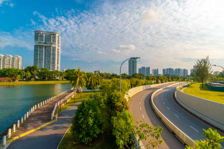 Highway in the park with modern buildings in the background, China.の写真素材