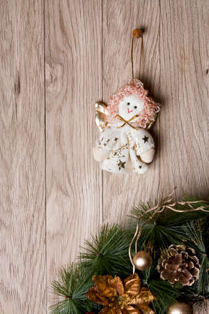 Christmas decoration - angel and wreath  hanging over wooden backgroundの写真素材