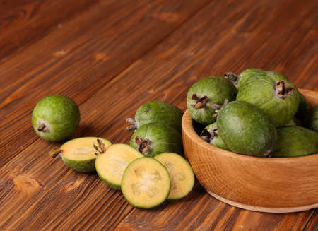 Fruits of feijoa in a wooden bowl on the tableの写真素材