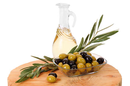 Olive oil in a transparent jar, green and black olives isolated on a white backgroundの写真素材