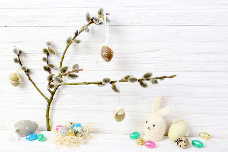 Easter eggs, rabbit and  catkins on a wooden background