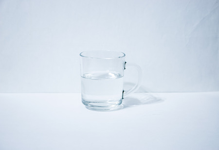 One glass with water light backgroundの写真素材