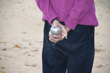 Players bocce ball  back with the ball in handの写真素材