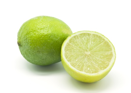 A whole lime and half a lime on white backgroundの写真素材