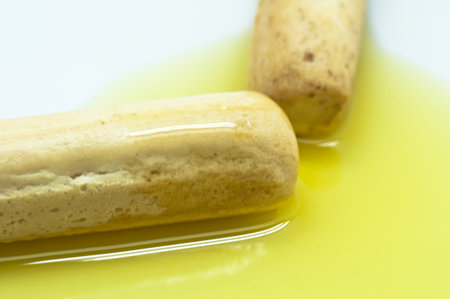 Two sticks closeup of bread with olive oil