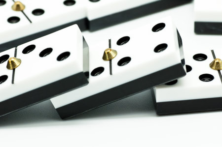 Several fallen dominoes on white backgroundの写真素材
