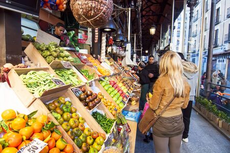 MADRID, SPAIN-OCTOBER 27: Unidentified people shopping in the famous market of San Miguel on October 27, 2011 in Madrid, Spain It retains its original iron structure of the early twentieth century. It has two floors and an area of ??1,200 square metersのeditorial素材