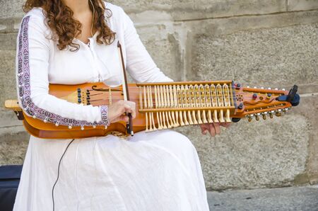 Woman Playing in the street a medieval instrumentの写真素材
