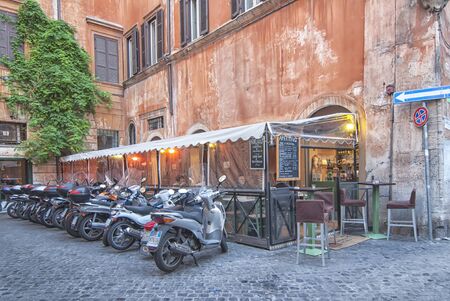 ROME, ITALY-OCTOBER 17: Motorcycle parking next to the terrace of a restaurant on October 17.2011 in Rome, Italy.  The motorcycle is one of the most used transport in the city of Romeのeditorial素材
