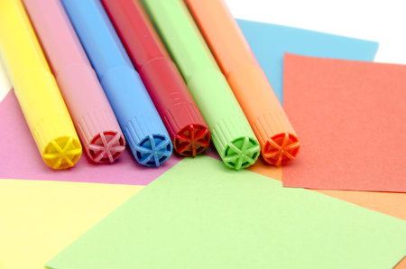 Different colored pens with colored paperの写真素材