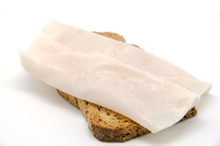 Toast bread with turkey ham slice on white backgroundの写真素材