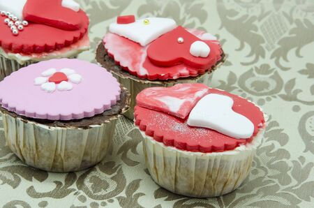 Gourmet cupcakes with hearts and decorationsの写真素材