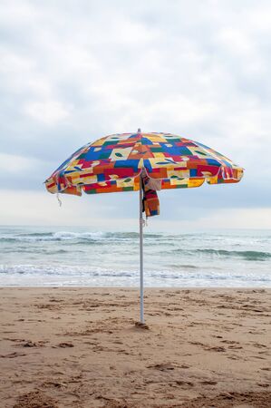 Colorful Umbrella on the beach with no one in Gandia, Valenciaの写真素材
