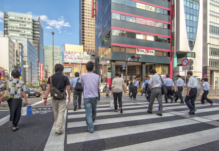 TOKYO,JAPAN-JULY 5: Unidentified people crossing in zebra crossing located in...