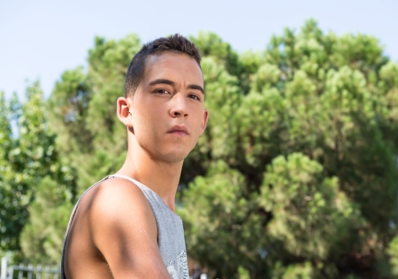 Sweaty young athlete playing basketball outdoorsの写真素材